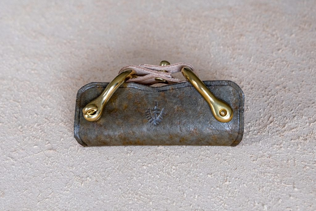 lerif designs leather horse buckle key holder vinegaroon on beige background