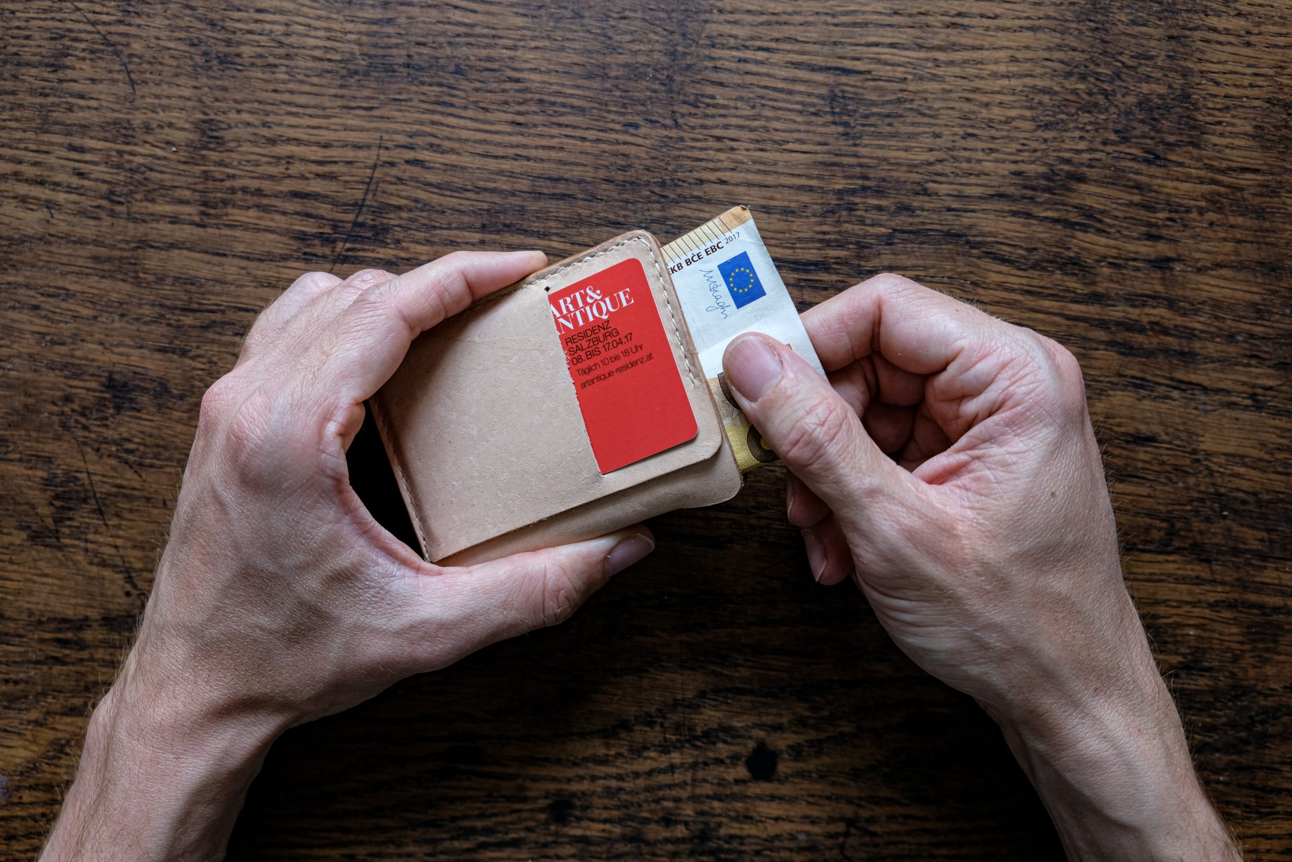 lerif designs Vale leather wallet in natural hands demo on wood background