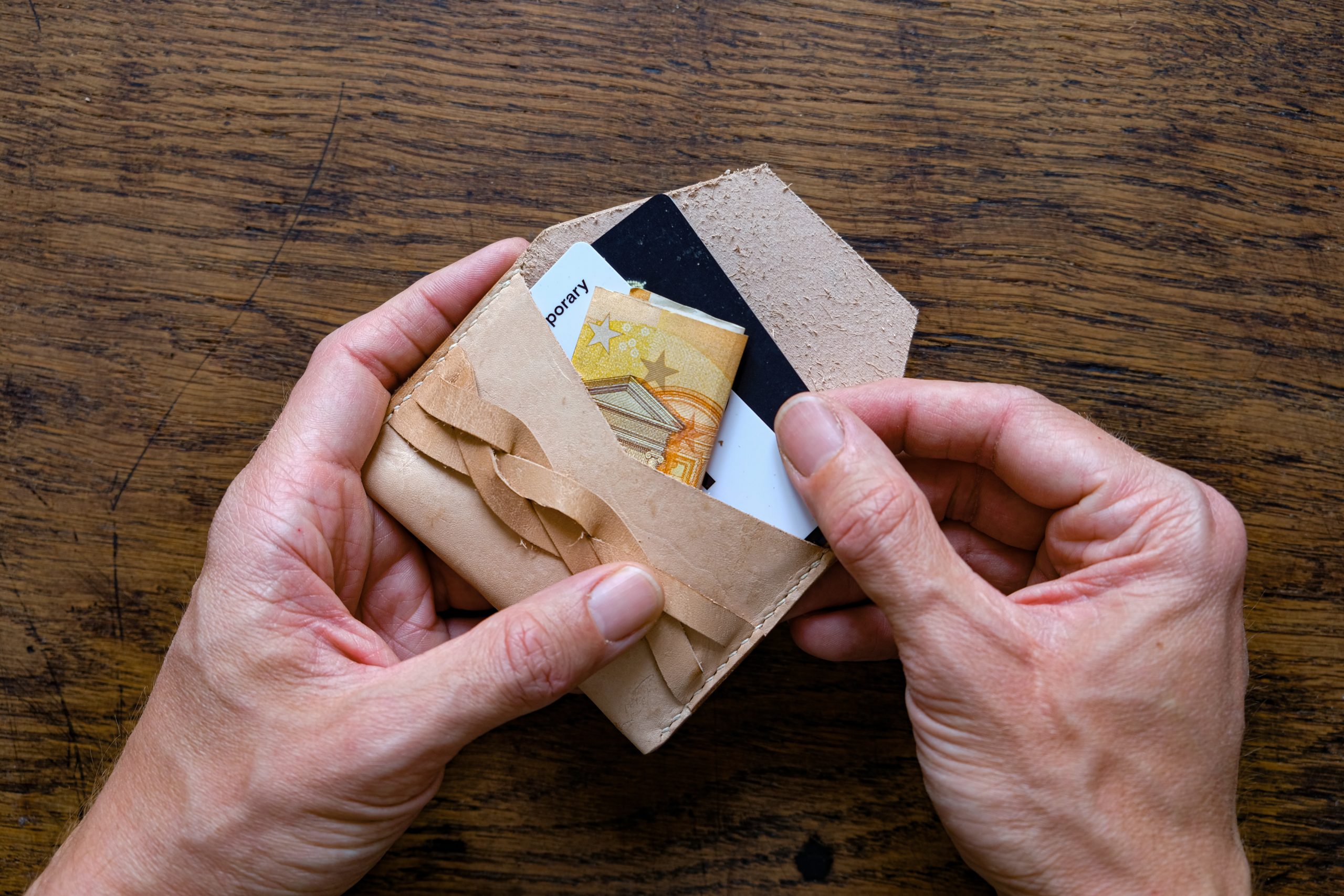 lerif designs leather magic braid cardholder hands demo on wood background